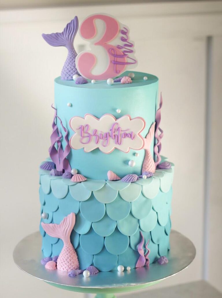 "Mermaid Themed Cake: A stunning confection adorned with fish scale fondant decoration and intricate mermaid tails, capturing the enchanting beauty of an underwater world in delicious detail."