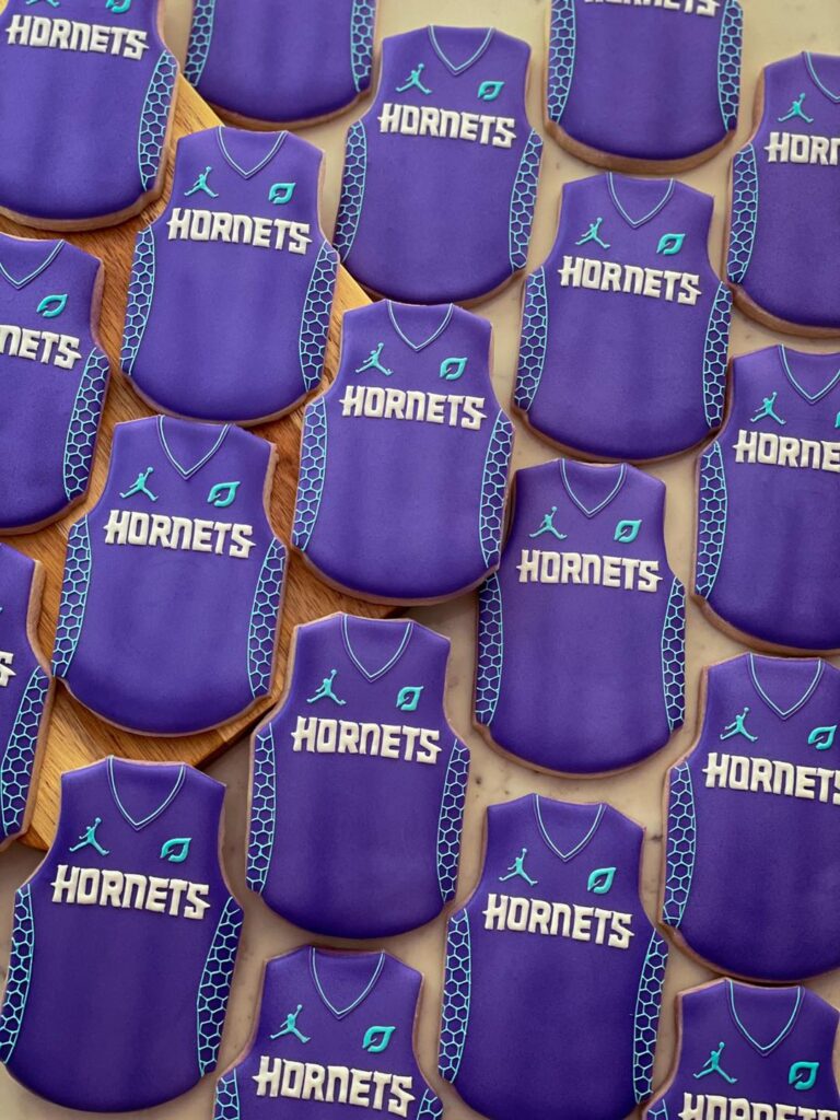 Hornets Jersey Cookies: A sweet celebration of the new style of jersey for the Hornets. These cookies are meticulously crafted to resemble the team's vibrant and updated jerseys, making them a delicious and festive treat for fans and enthusiasts