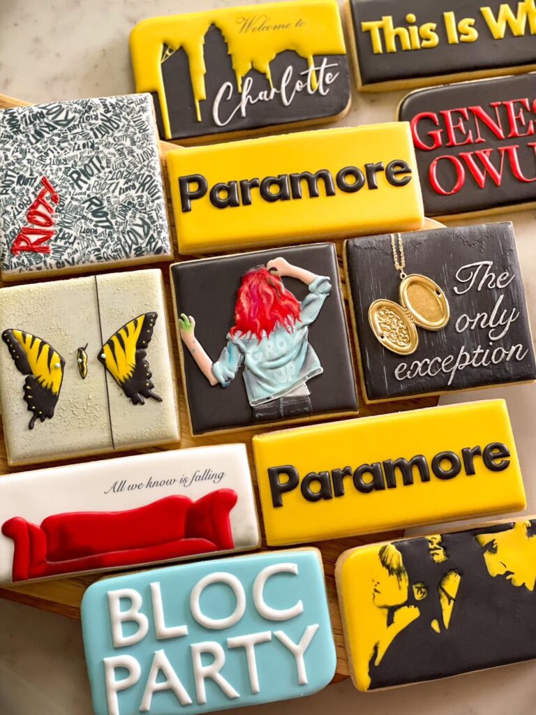 Cookies for Paramore Charlotte Show: Intricately detailed treats featuring elements from their songs and details from previous albums. Crafted to commemorate the concert at the Spectrum Center, these cookies capture the essence of Paramore's music in a sweet and artistic display