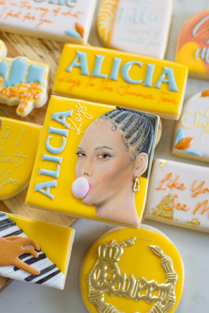 Cookies for Alicia Keys' Charlotte Show: A sweet tribute featuring a hand-painted portrait cookie of Alicia Keys, alongside intricately designed treats celebrating her music. These cookies are a delightful and artistic homage to Alicia Keys' performance in Charlotte