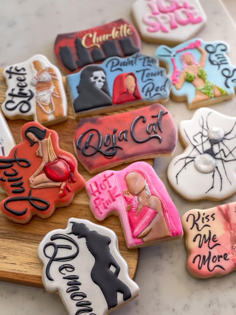 Doja Cat's Charlotte Show Cookies: A masterpiece of intricate details, capturing scenes from her music videos with meticulously piped icing. Each cookie is adorned with song titles and lyrics, showcasing a detailed and artistic celebration of Doja Cat's music at the Charlotte show